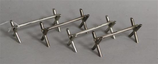 A matched set of four silver knife rests by Mappin & Webb, Sheffield, 1902(2) & 1910(2), 9cm.